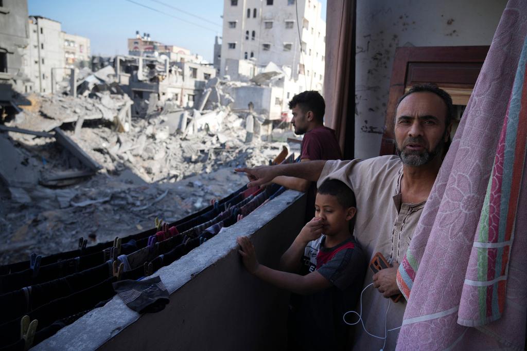 Palestinian points at destruction by the Israeli bombardment of the Gaza Strip in the Maghazi refugee camp