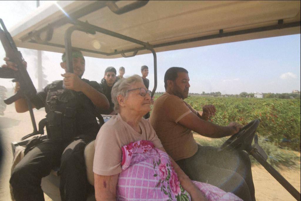 Hamas' terrorists transport Yaffa Adar, 85, an Israeli civilian kidnapped from Nir Oz, into Gaza strip in a golf cart