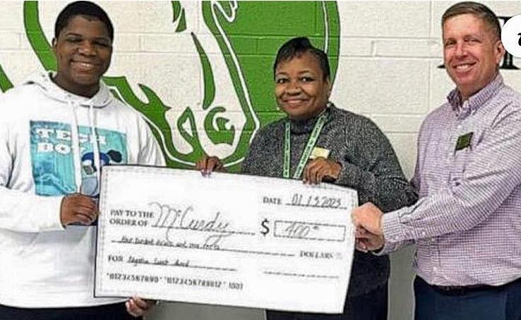 DJ Strickland presenting check to teachers