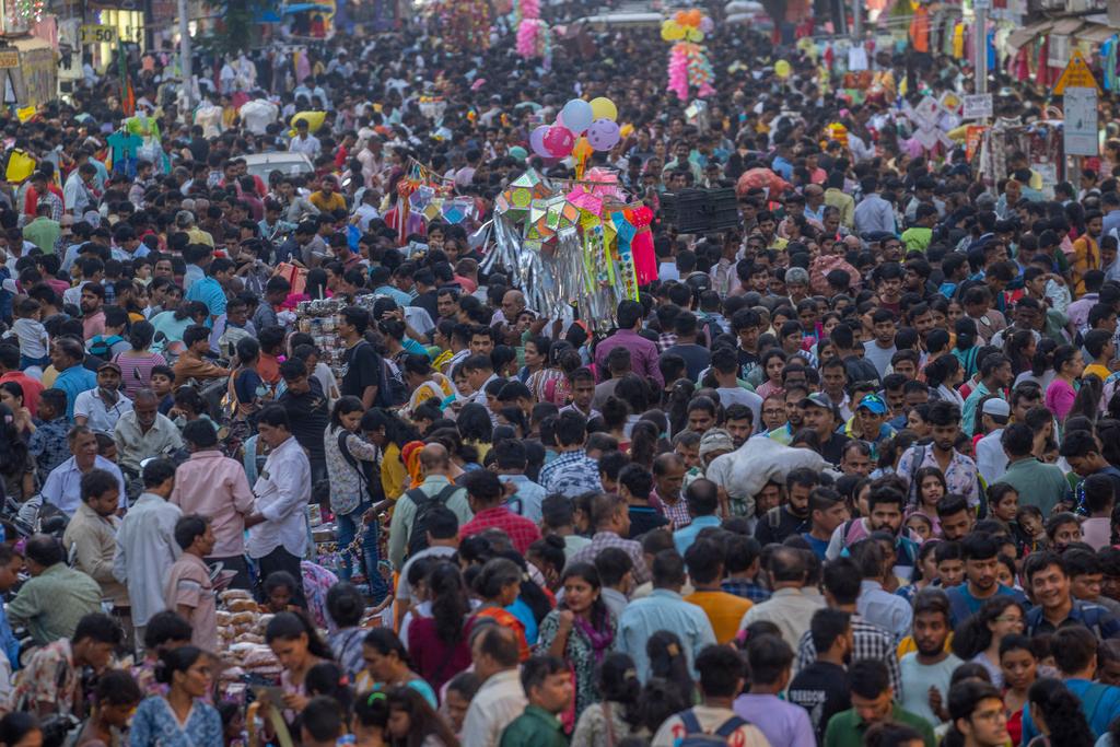 People crowd a market as they shop ahead of Diwali festival in Mumbai, India