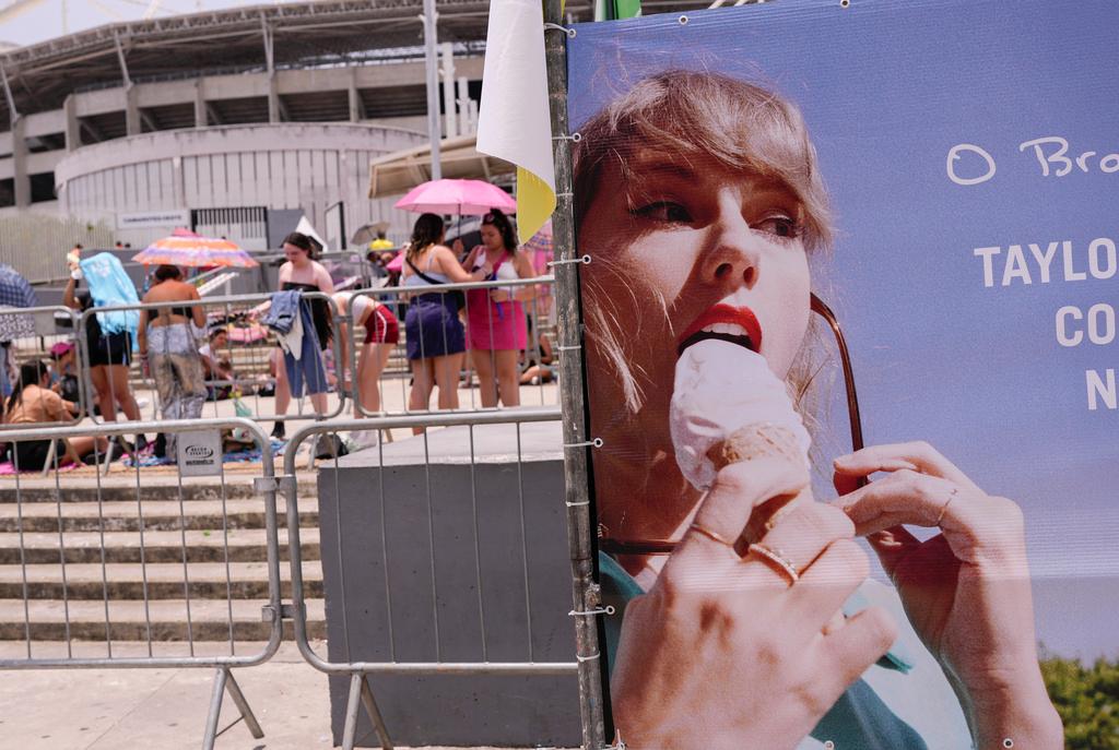 Taylor Swift fans wait for the doors of Nilton Santos Olympic stadium to open for her Eras Tour concert amid a heat wave in Rio de Janeiro, Brazil, Saturday, Nov. 18, 2023.