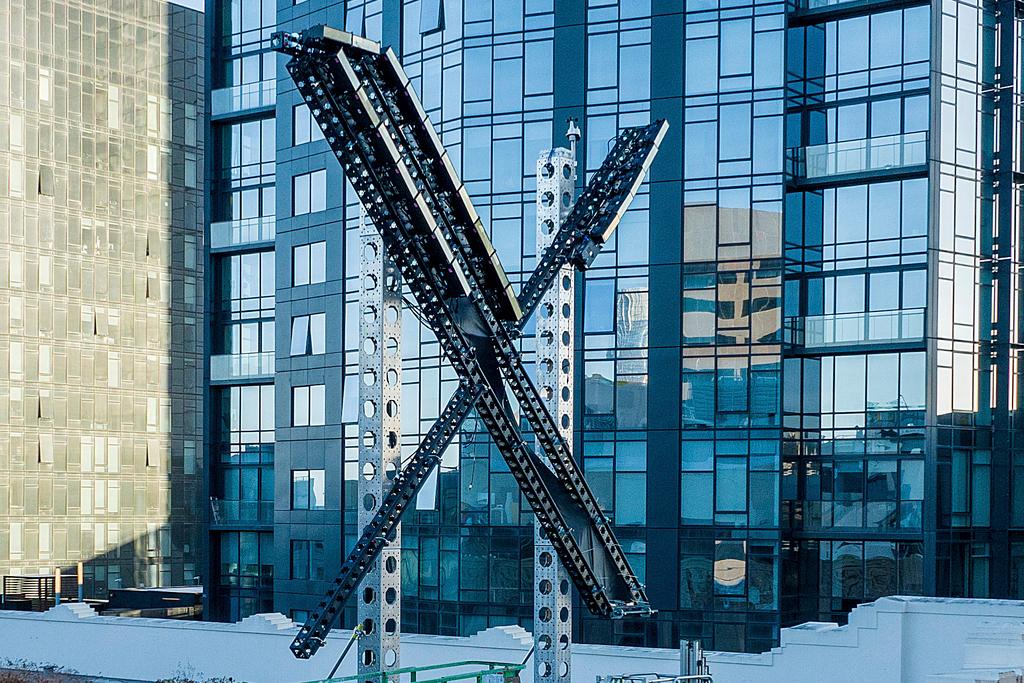 An "X" sign sits atop the social media platform's headquarters, in San Francisco, on July 28, 2023