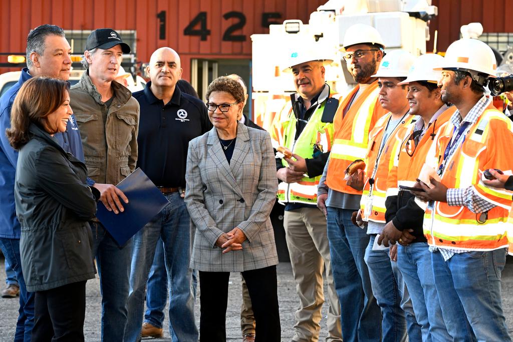 Vice President Kamala Harris, left, greets freeway construction workers with Sen. Alex Padilla, California Gov. Gavin Newsom, third from left, and Los Angeles Mayor Karen Bass, center