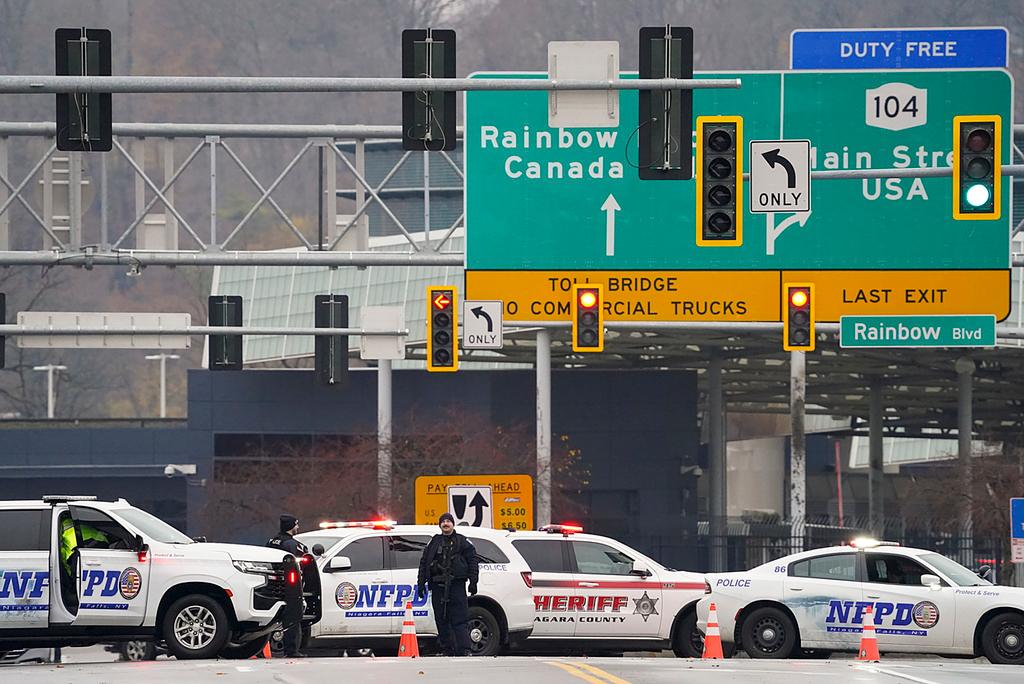 Law enforcement personnel block off the entrance to the Rainbow Bridge, Wednesday, Nov. 22, 2023, in Niagara Falls, N.Y. The border crossing between the U.S. and Canada has been closed after a vehicle exploded at a checkpoint on a bridge near Niagara Falls. 