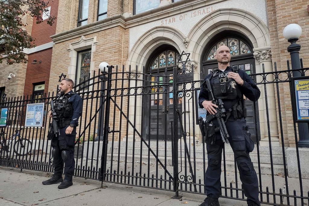 Hoboken Police officers stand watch outside the United Synagogue of Hoboken, NJ