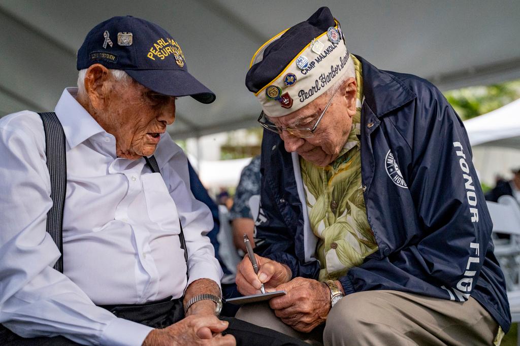 Pearl Harbor survivors Harry Chandler, 102, left, and Herb Elfring, 101, talk to each other during the 82nd Pearl Harbor Remembrance Day ceremony 