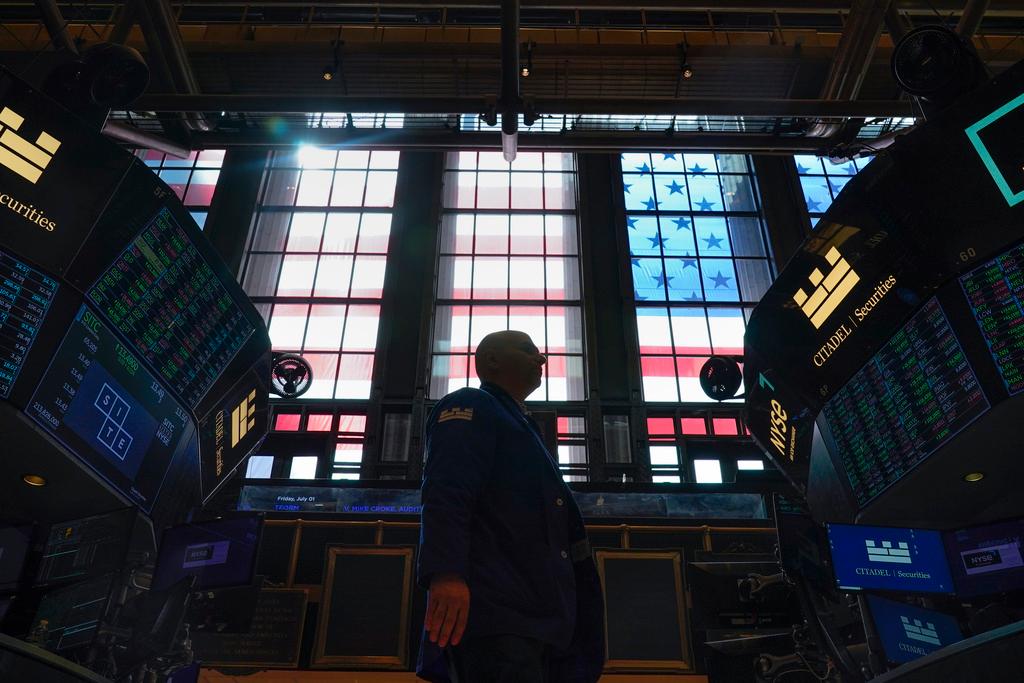 Traders work on the floor at the New York Stock Exchange in New York