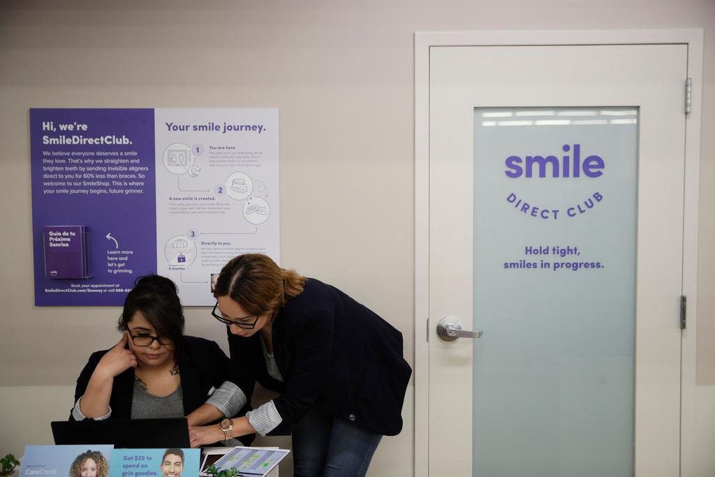 Dental assistants go over appointments at SmileDirectClub's SmileShop located inside a CVS store in Downey, Calif.