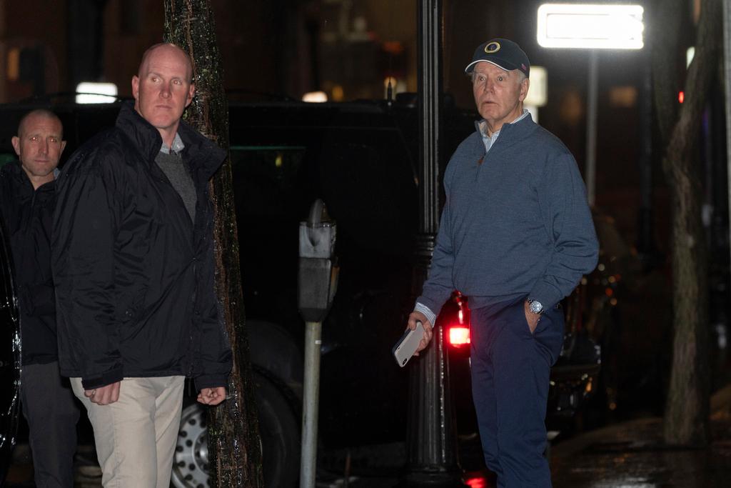 President Joe Biden reacts after hearing a loud bang as he leaves his campaign headquarters in Wilmington, Del., Sunday, Dec. 17, 2023.