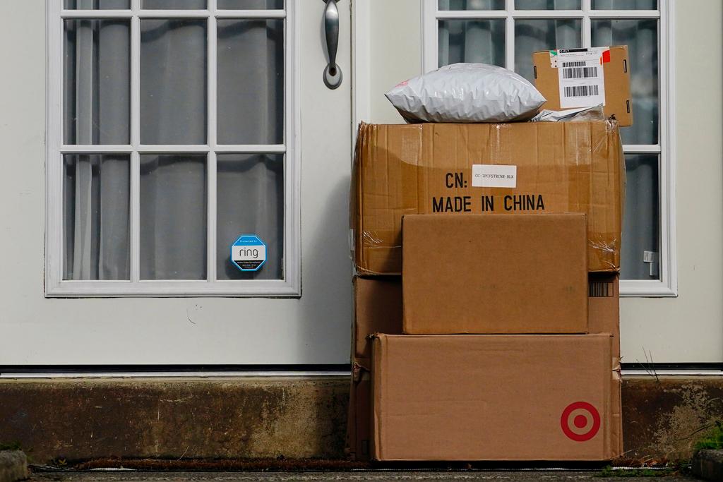 Packages are stacked on the doorstep of a home on Oct. 27, 2021, in Upper Darby, Pa.