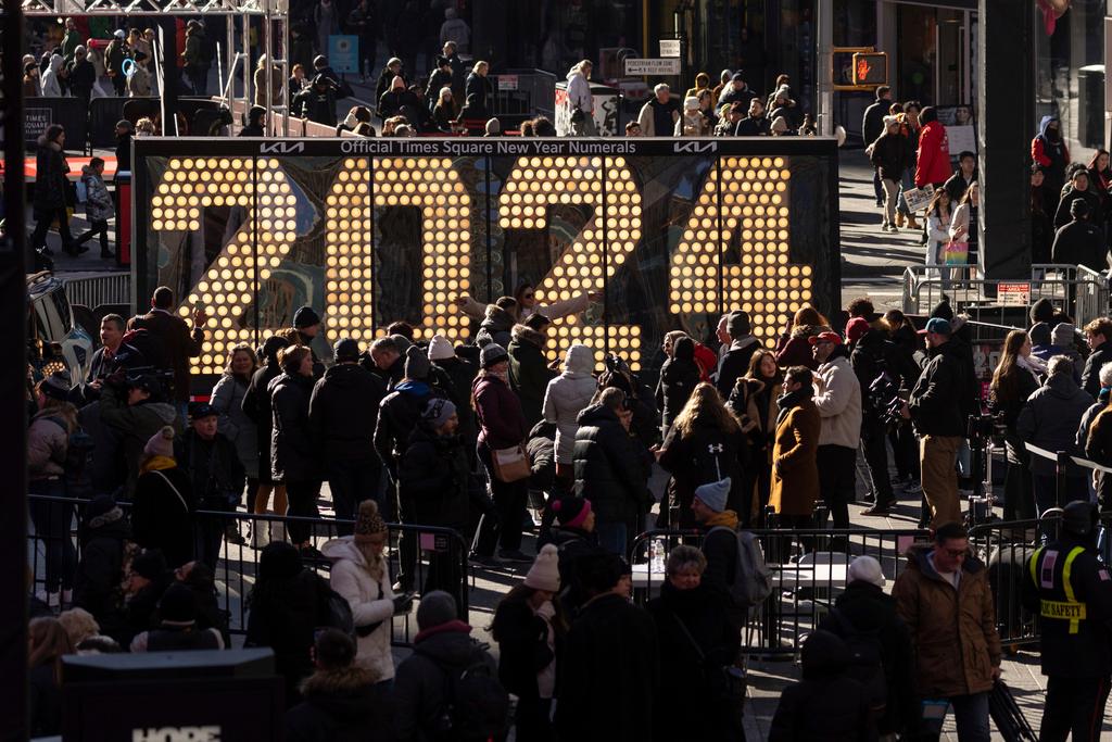 eople gather around the 2024 New Year's Eve numerals displayed in Times Square, Wednesday, Dec. 20, 2023, in New York.