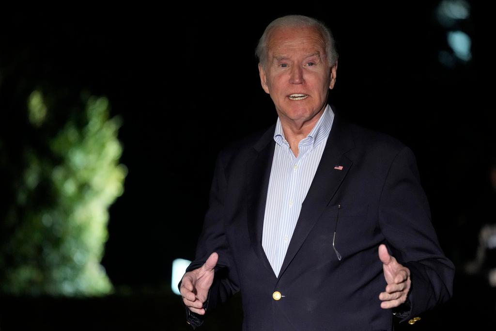 President Joe Biden responds to a question as he walks back to the White House in Washington, Jan. 2, 2024