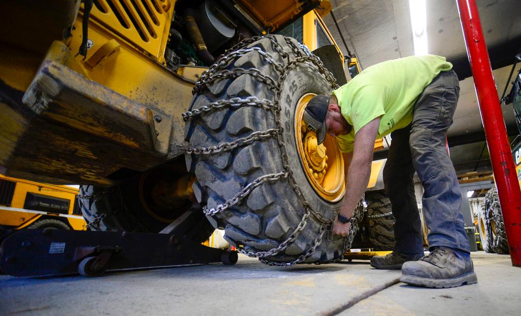 Andy Brown, a highway equipment operator for the Brattleboro, Vt., Public Works Department, puts chains onto a vehicle on Friday, Jan. 5, 2024, in anticipation of this weekend's snow storm.