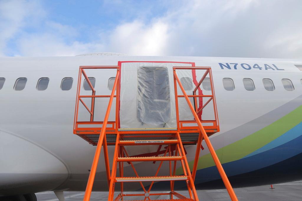 This photo released by the National Transportation Safety Board shows a gaping hole where the paneled-over door had been at the fuselage plug area of Alaska Airlines Flight 1282 on Sunday, Jan. 7, 2024, in Portland, Ore. 