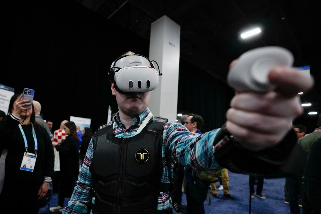 An attendee uses the bHaptics haptic vest during CES Unveiled before the start of the CES tech show