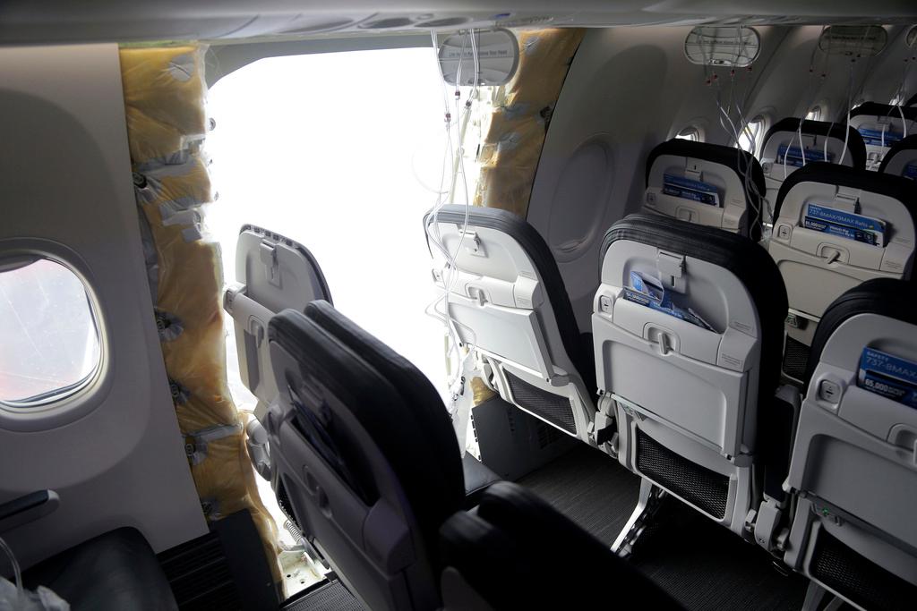Gaping hole where the paneled-over door had been at the fuselage plug area of Alaska Airlines Flight 1282
