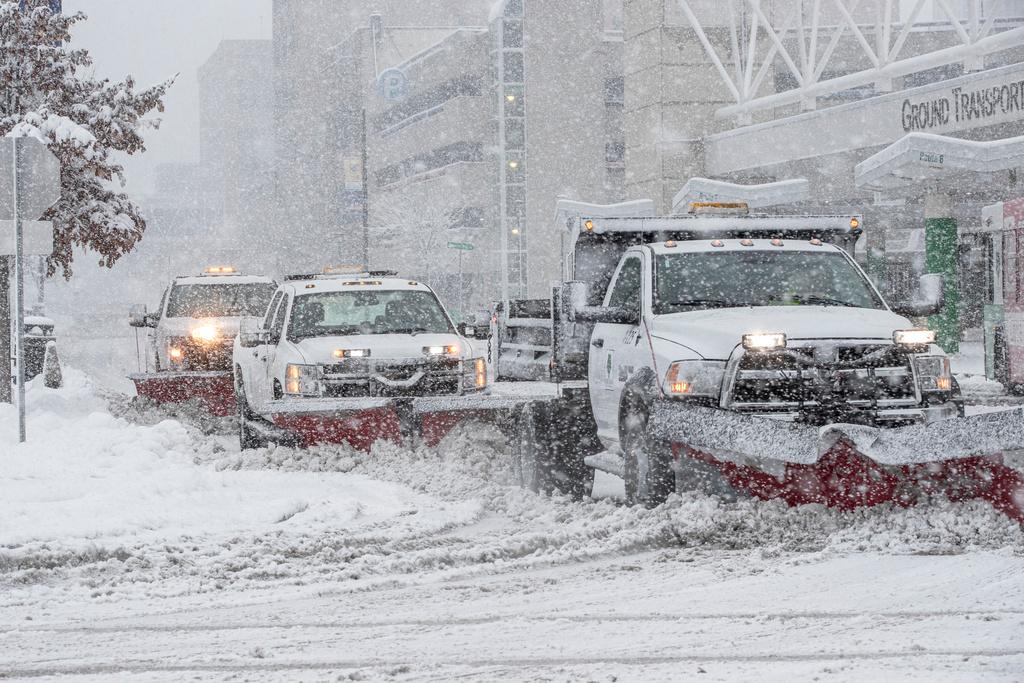 City of Cedar Rapids plows clear the street as snow falls in Cedar Rapids, Iowa