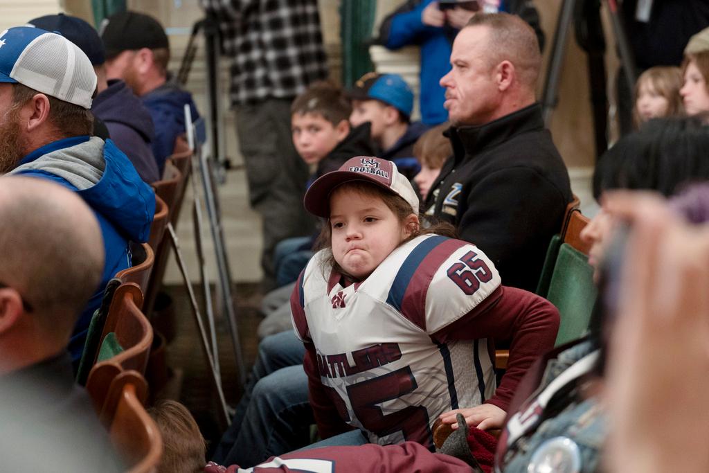 Bruce Bertram, 7, listens as lawmakers discuss a proposed bill that would ban children under 12 from playing tackle football in California