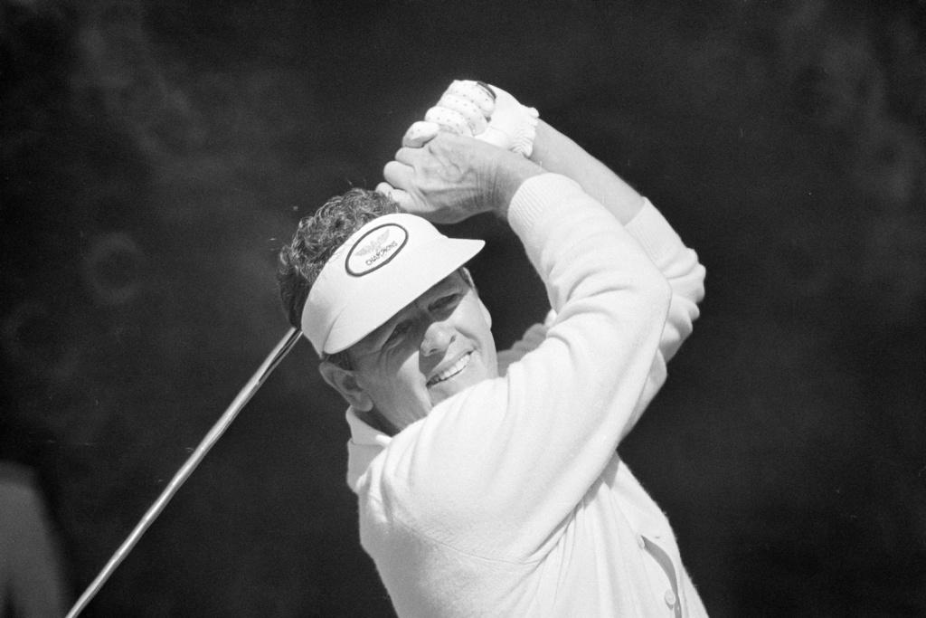 Former Masters champ Jack Burke tees off during practice