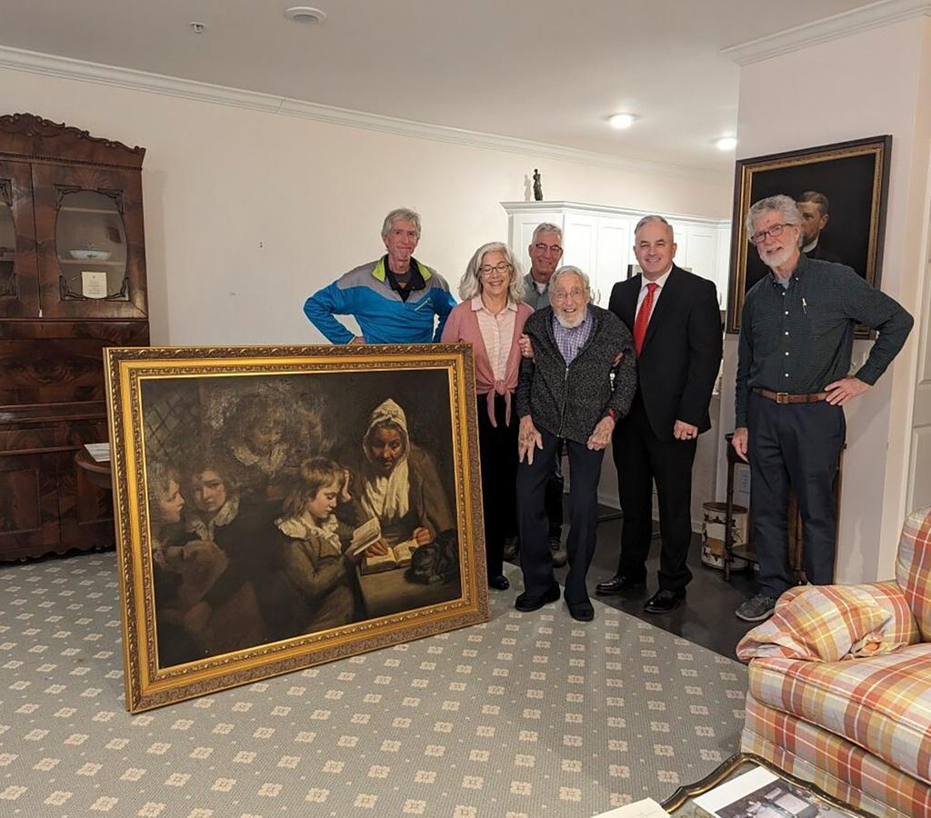 Federal agents, owners stand next to painting that was stolen