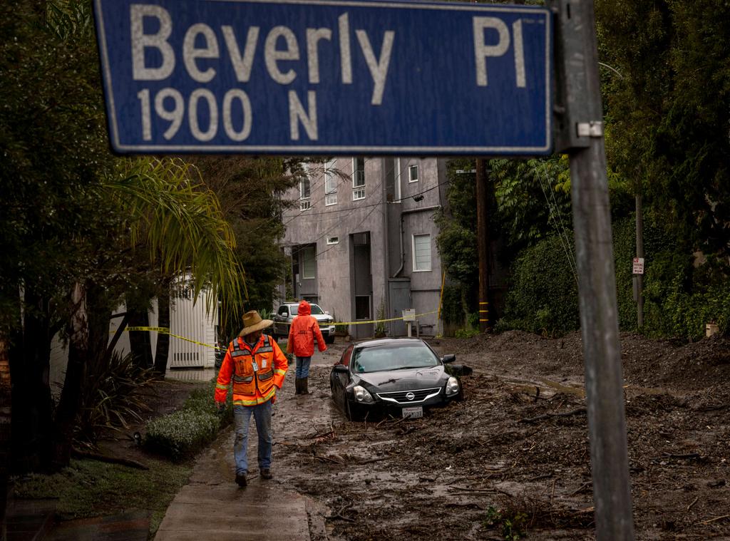 Workers survey a mudslide in the Beverly Crest area of Los Angeles.