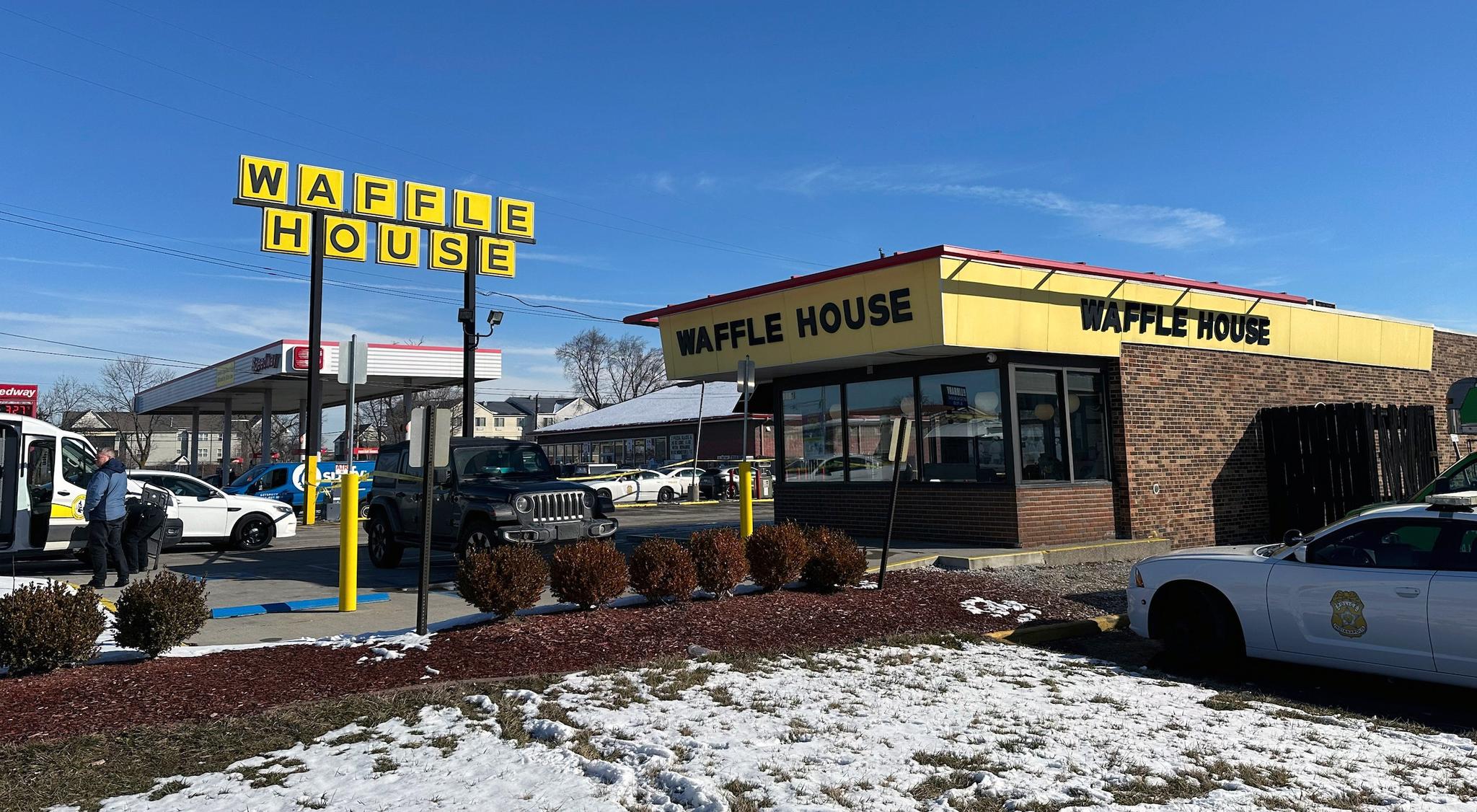Waffle House with snow around it and police officers