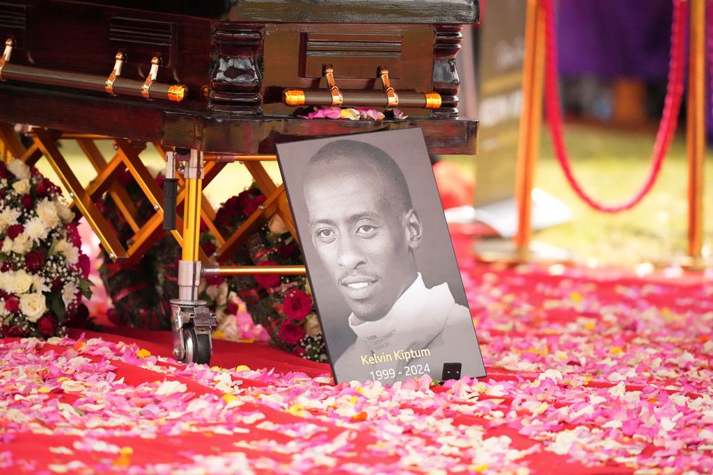 A portrait of Kelvin Kiptum next to his casket is seen ahead of his burial, in Elgeyo Marakwet, Kenya