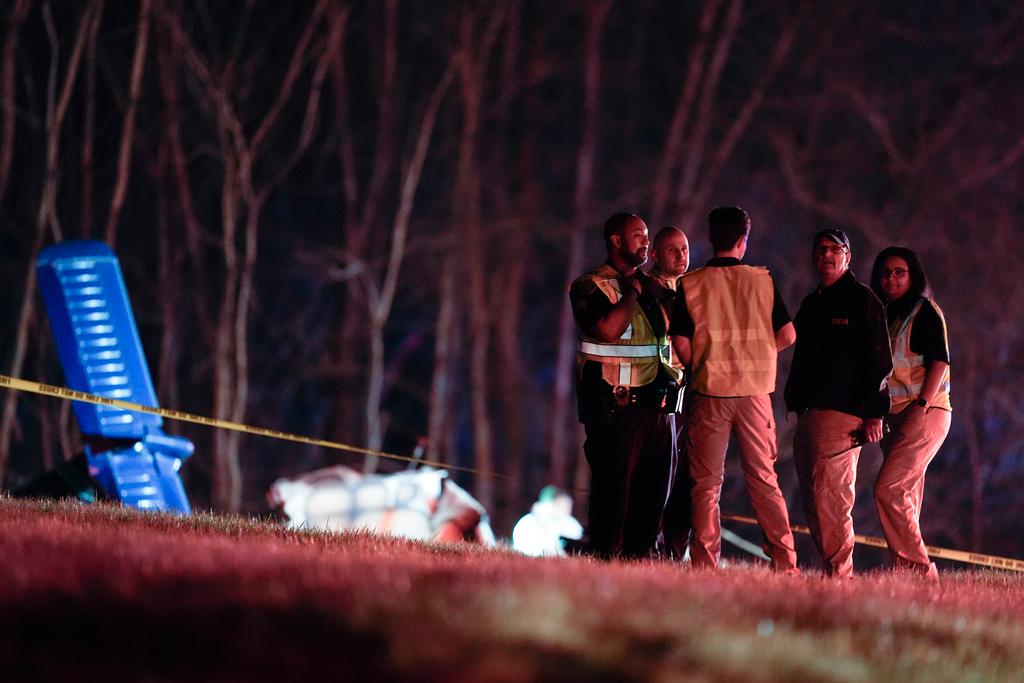 Emergency officials work the scene of a fatal small plane crash alongside Interstate 40 near mile marker 202, Monday, March 4, 2024, in Nashville, Tenn.