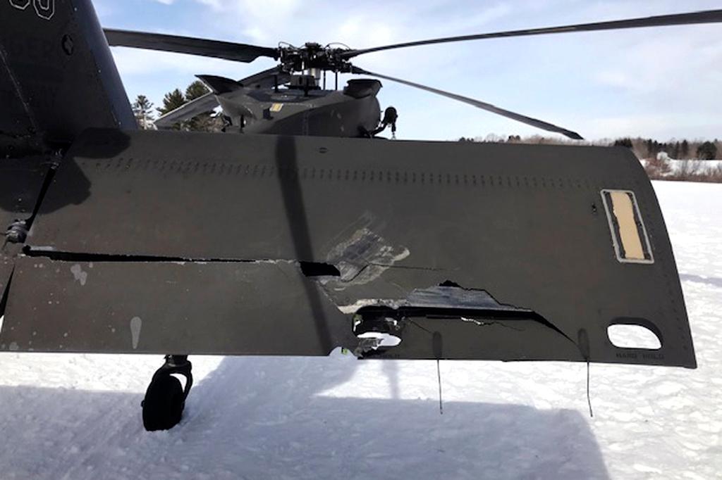 In this U.S. Army photograph by attorney Douglas Desjardins, a damaged Black Hawk helicopter rests on the snow, March 13, 2019, in Worthington, Mass.