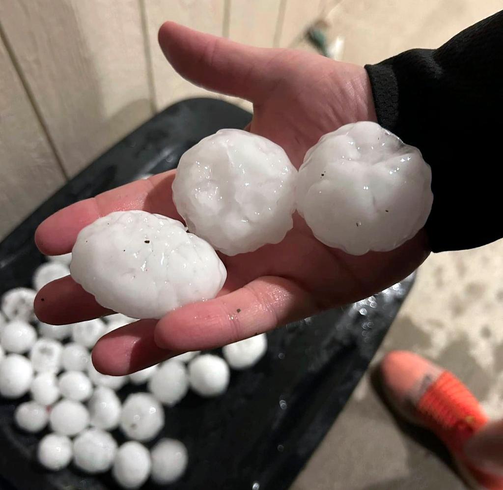 In this image provided by Jeremy Crabtree, large chunks of hail are shown, Wednesday night, March 13, 2024, in Shawnee, Kan.