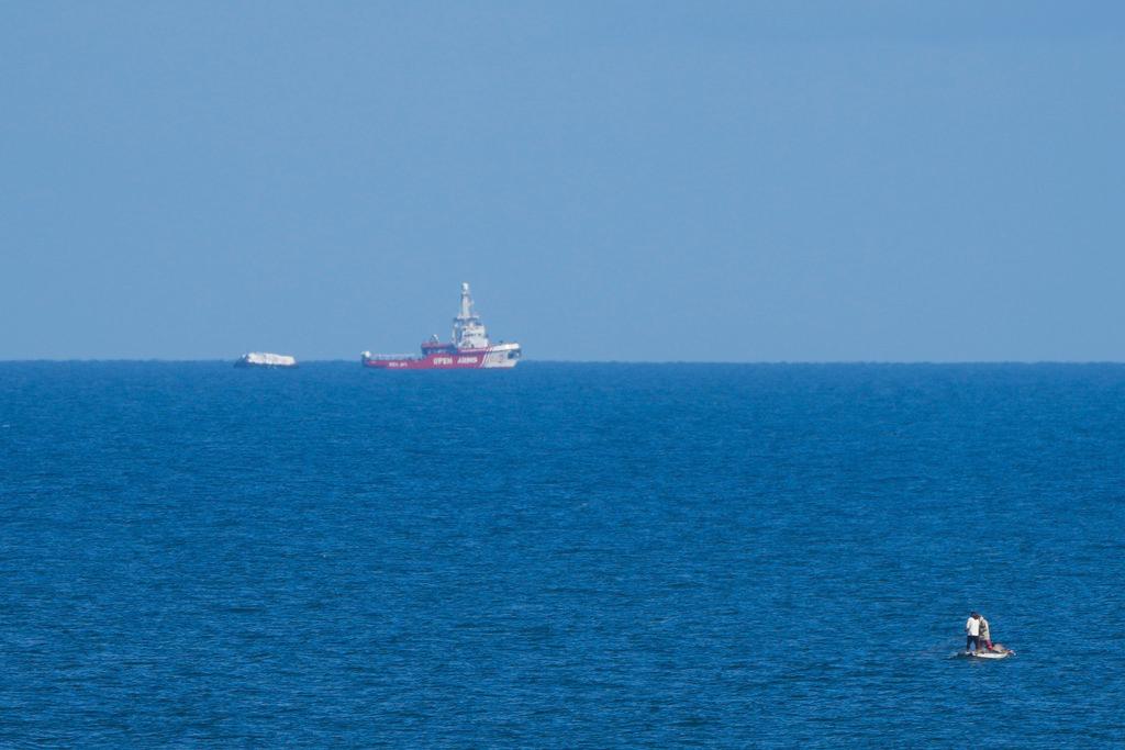 A ship belonging to the Open Arms aid group approaches the shores of Gaza towing a barge with 200 tons of humanitarian aid on Friday, March 15, 2024.