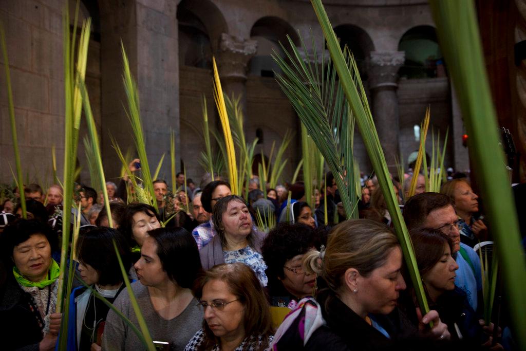 Christian worshippers hold palm fronds during the Palm Sunday procession at Church of the Holy Sepulchre, traditionally believed by many to be the site of the burial of Jesus Christ, in Jerusalem's Old City