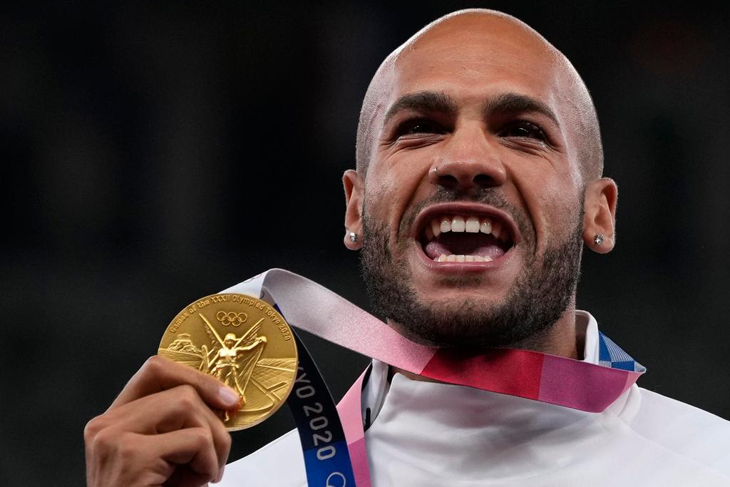 Lamont Marcell Jacobs, of Italy poses with his gold medal following the men's 100-meters final at the 2020 Summer Olympics, Monday, Aug. 2, 2021, in Tokyo.