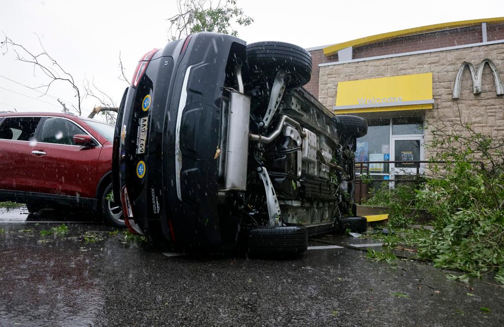 A car is flipped at McDonalds on Old Spanish Trail after an apparent tornado touched down in south Slidell, La.