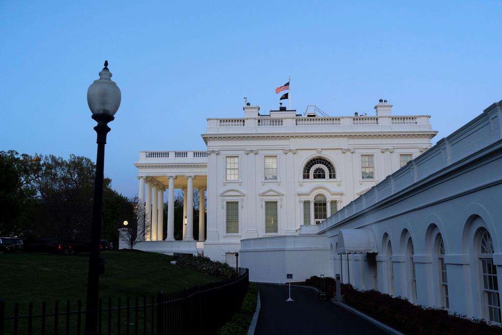 The White House is seen as dusk falls, Sunday, April 14, 2024, in Washington.