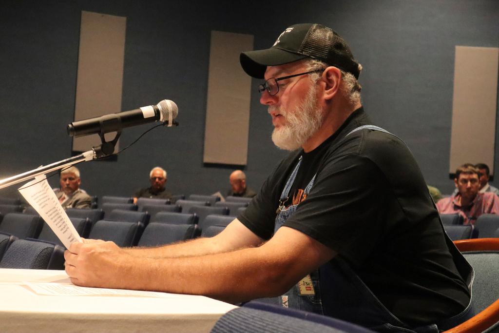 Retired coal miner with black lung disease speaks during a public hearing