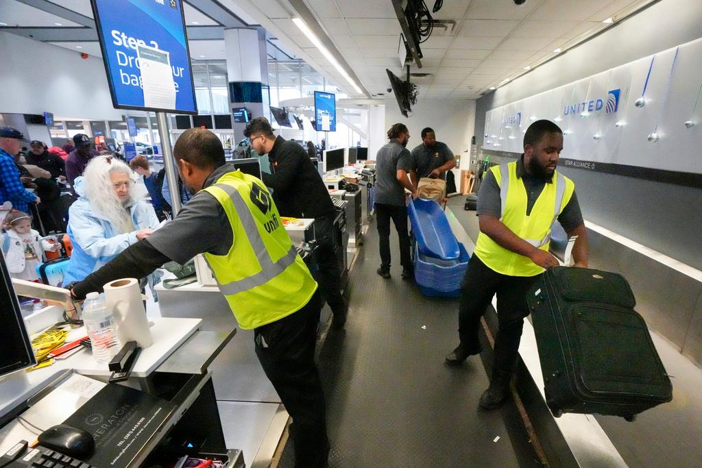 Passengers drop off their baggage at United Airlines in C Terminal at George Bush Intercontinental Airport, Houston 