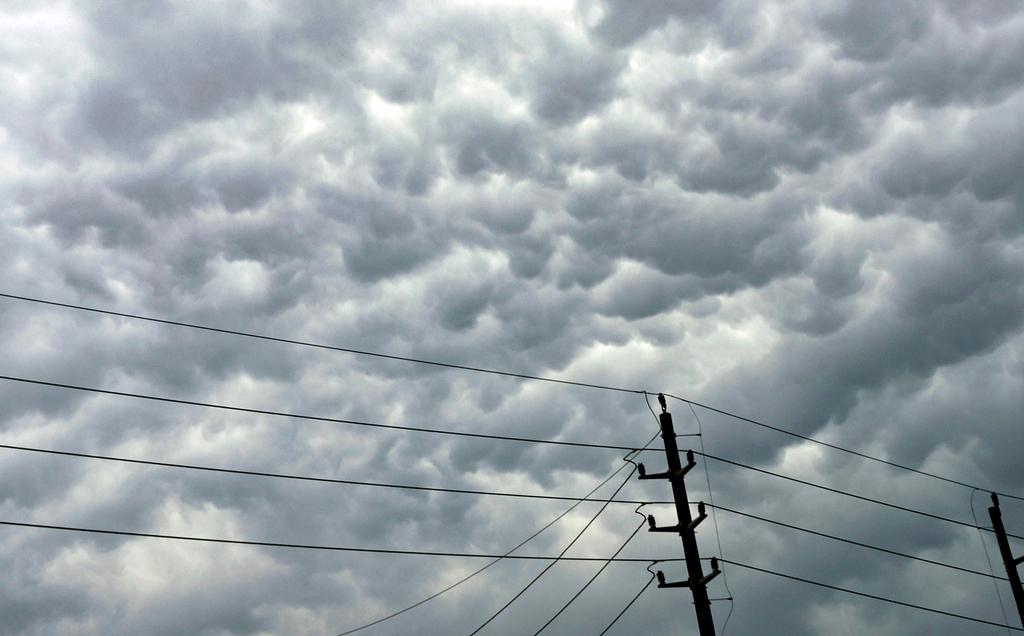 Clouds amass over power lines follow days of storms on Sunday, May 5, 2024, in Humble, Texas.