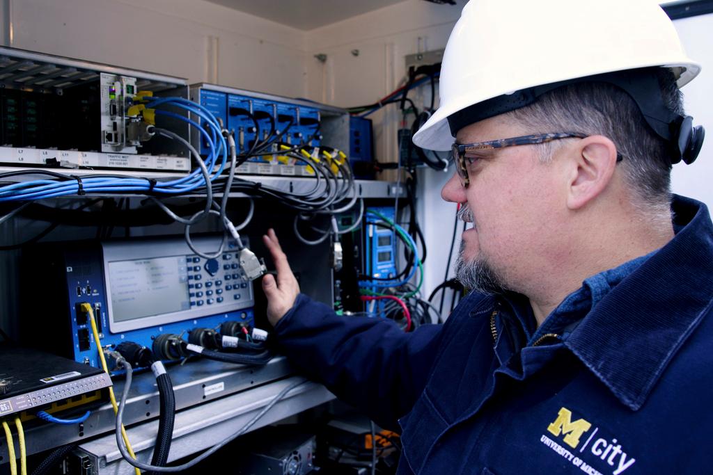  Jim Lollar, Mcity test facility manager, as he works inside of a traffic control cabinet at the Mcity Test Facility, identical to ones found at signalized intersections across the country.