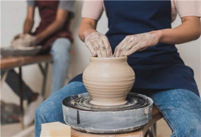Woman using pottery wheel