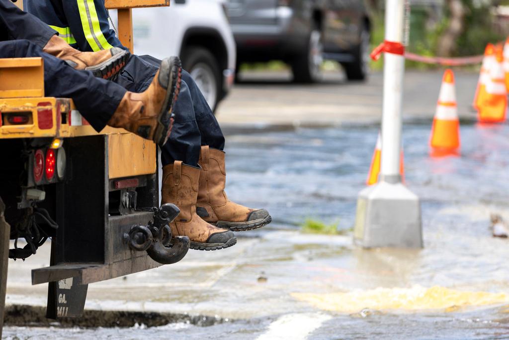 Workers arrive at a water main break at Joseph E. Boone Boulevard and James P. Brawley Drive in Atlanta
