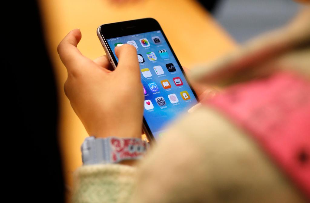 A child holds an iPhone at an Apple store on Sept. 25, 2015 in Chicago.
