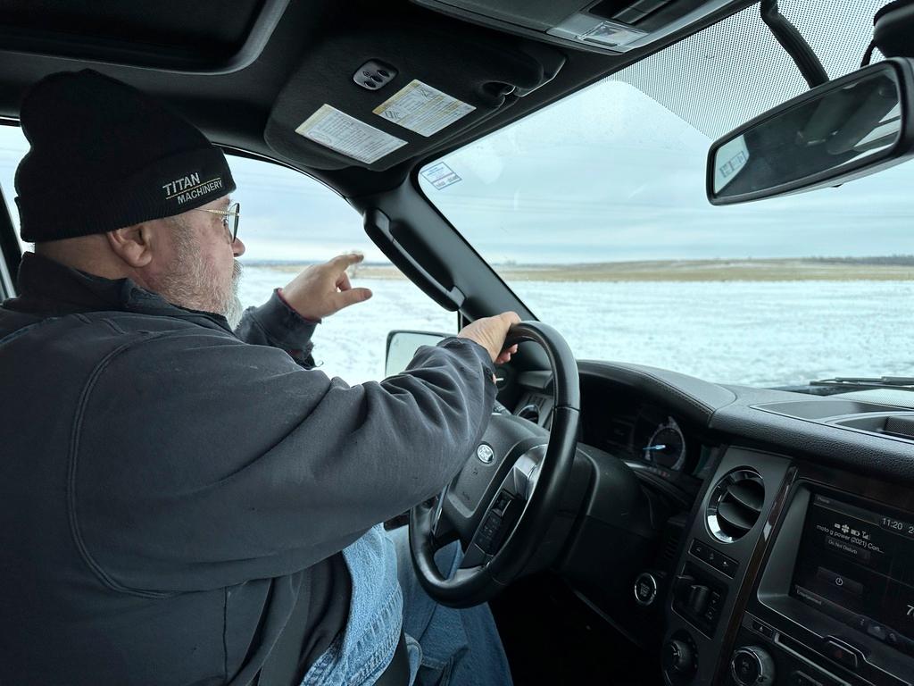 Dan McLean, shown Wednesday, March 6, 2024, points to where Summit Carbon Solutions' proposed carbon dioxide pipeline would cross his land near Menoken, N.D.