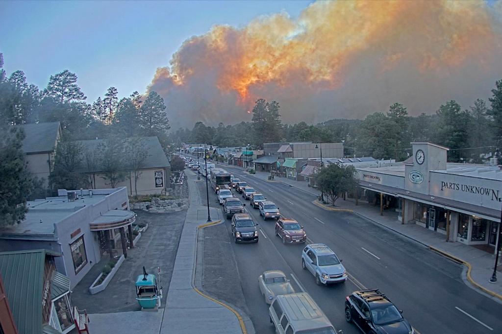In this image taken from webcam footage provided by the Village of Ruidoso, smoke rises behind Ruidoso, N.M., on Monday, June 17, 2024.