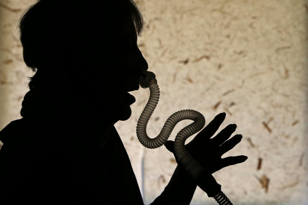 Person demonstrates how she puts on her sleep apnea breathing device