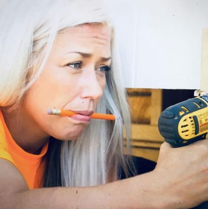 Alyssa using drill, holding pencil in mouth