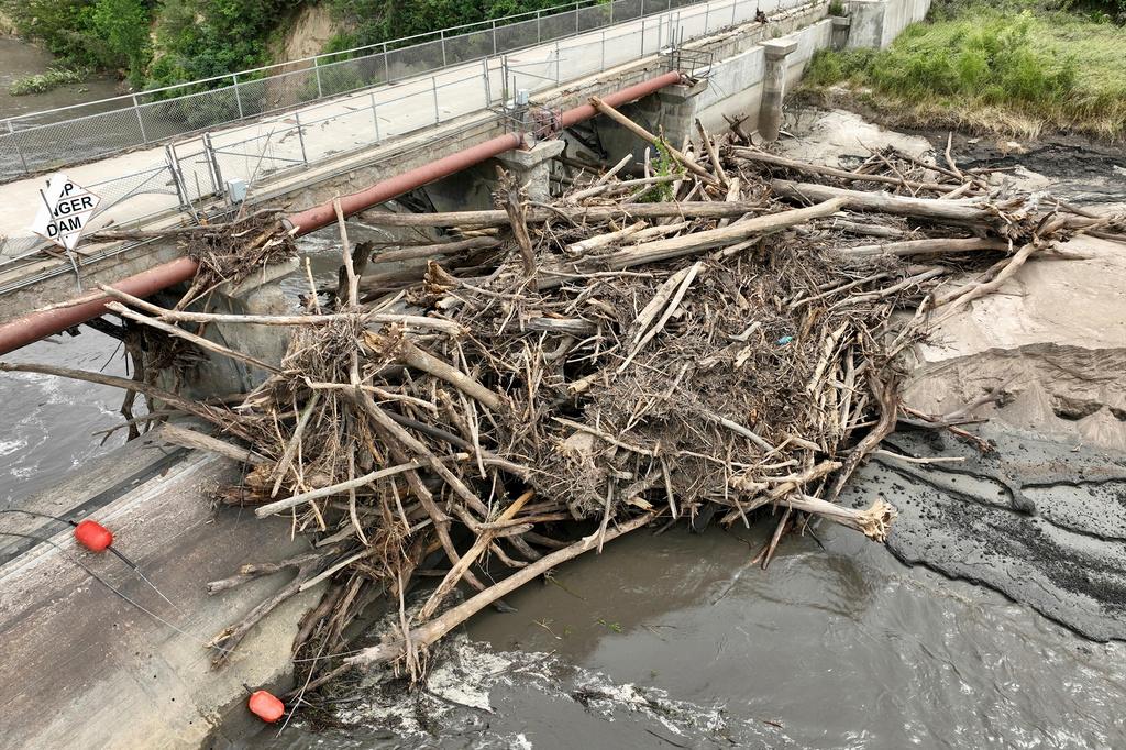 Floodwater continues to carve a channel around the Rapidan Dam