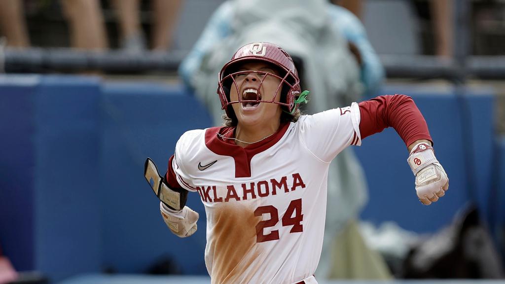 Oklahoma's Jayda Coleman (24) celebrates a two-run home run hit by Kinzie Hansen (9) in the third inning during an NCAA softball Women's College World Series game against Duke
