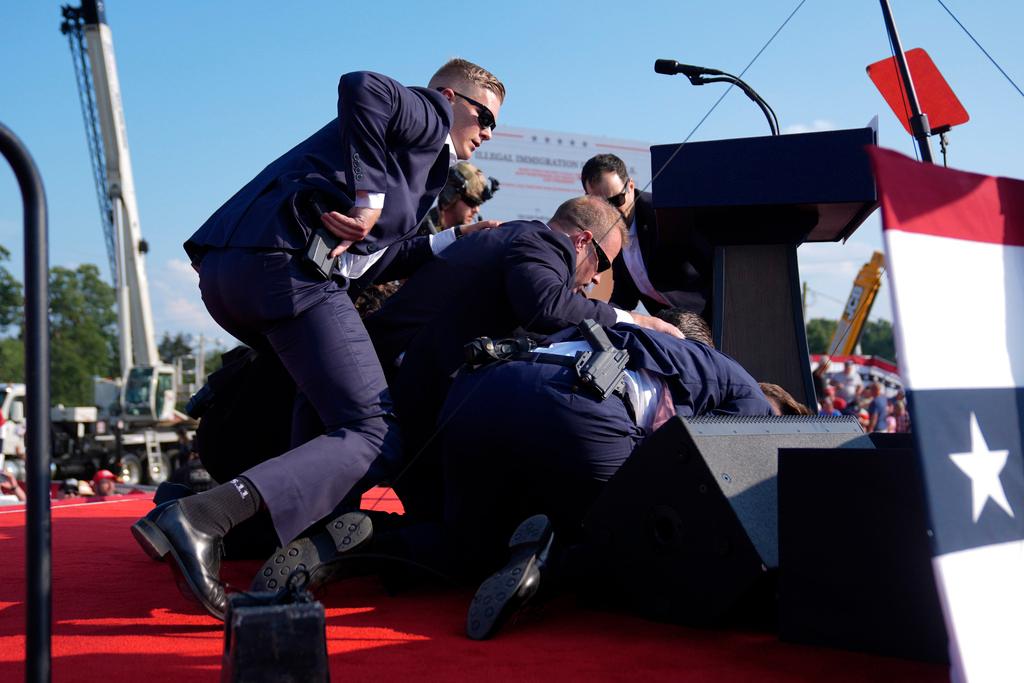 Republican presidential candidate former President Donald Trump is covered by U.S. Secret Service agents 