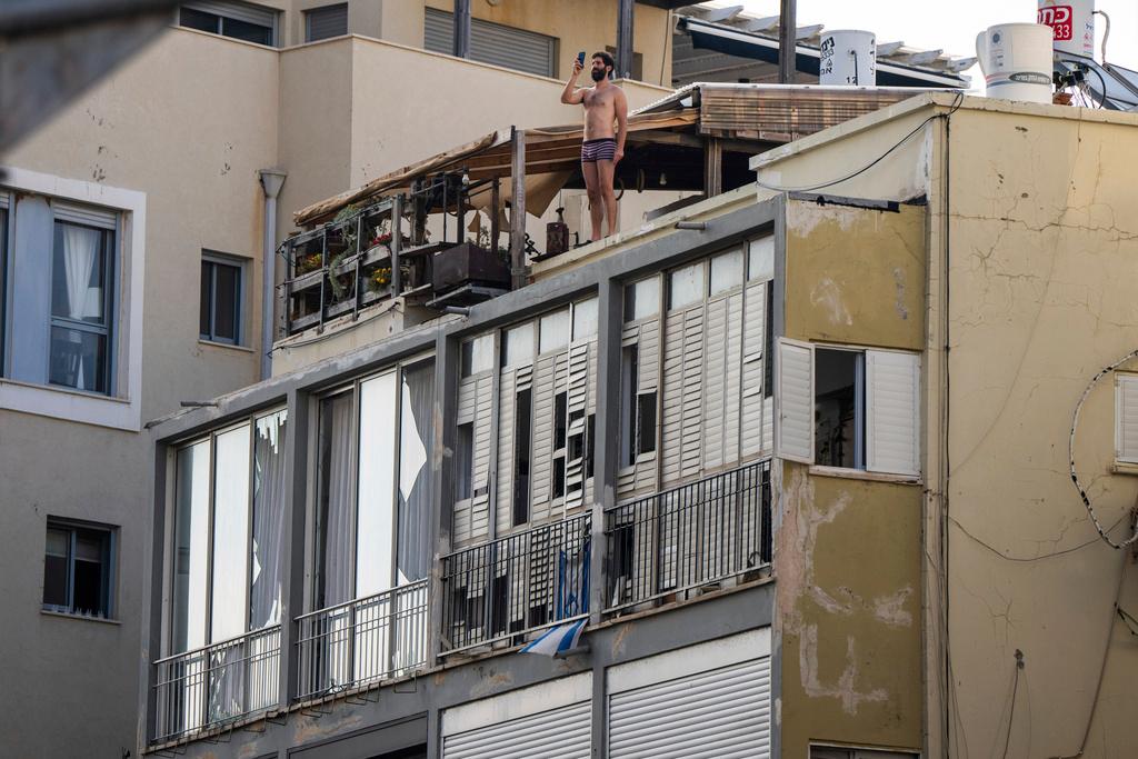 Israeli firefighter investigates the scene of a deadly explosion in Tel Aviv, Israel